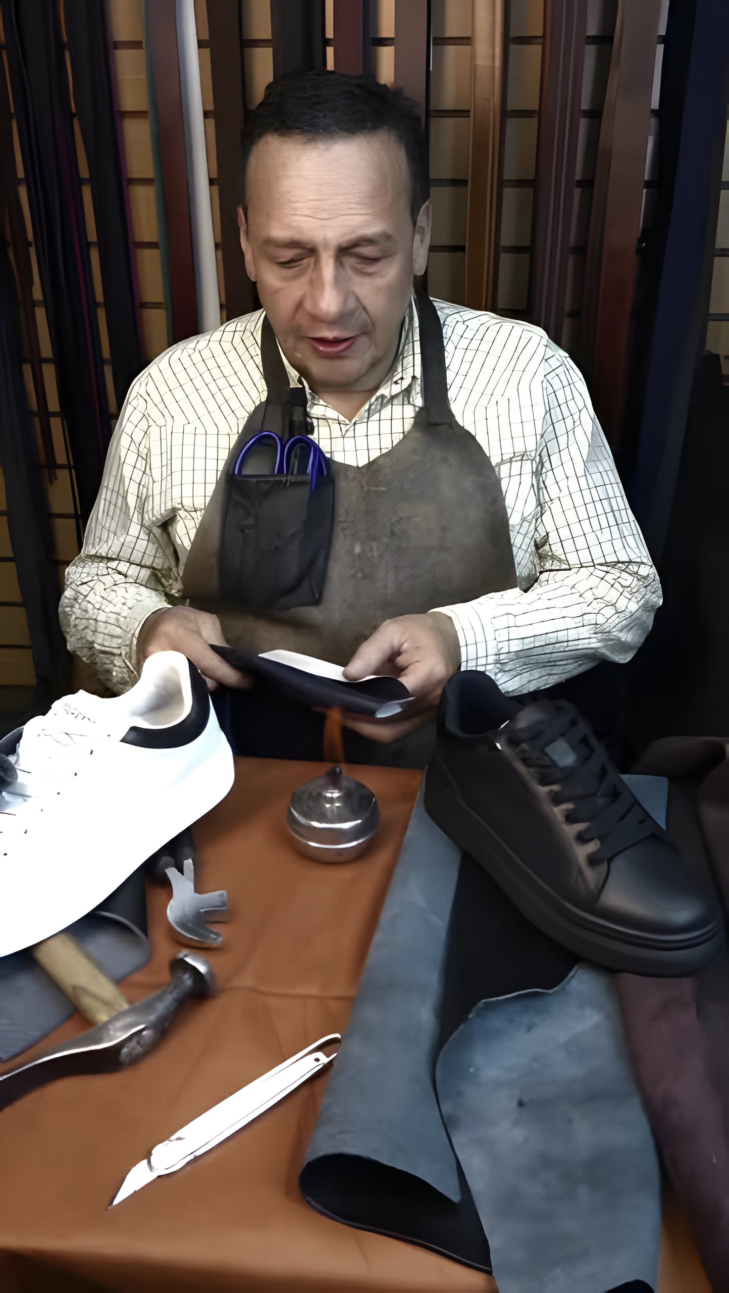 Maestro zapatero trabajando el cuero en su taller